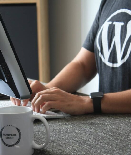 person in black and white t-shirt using computer